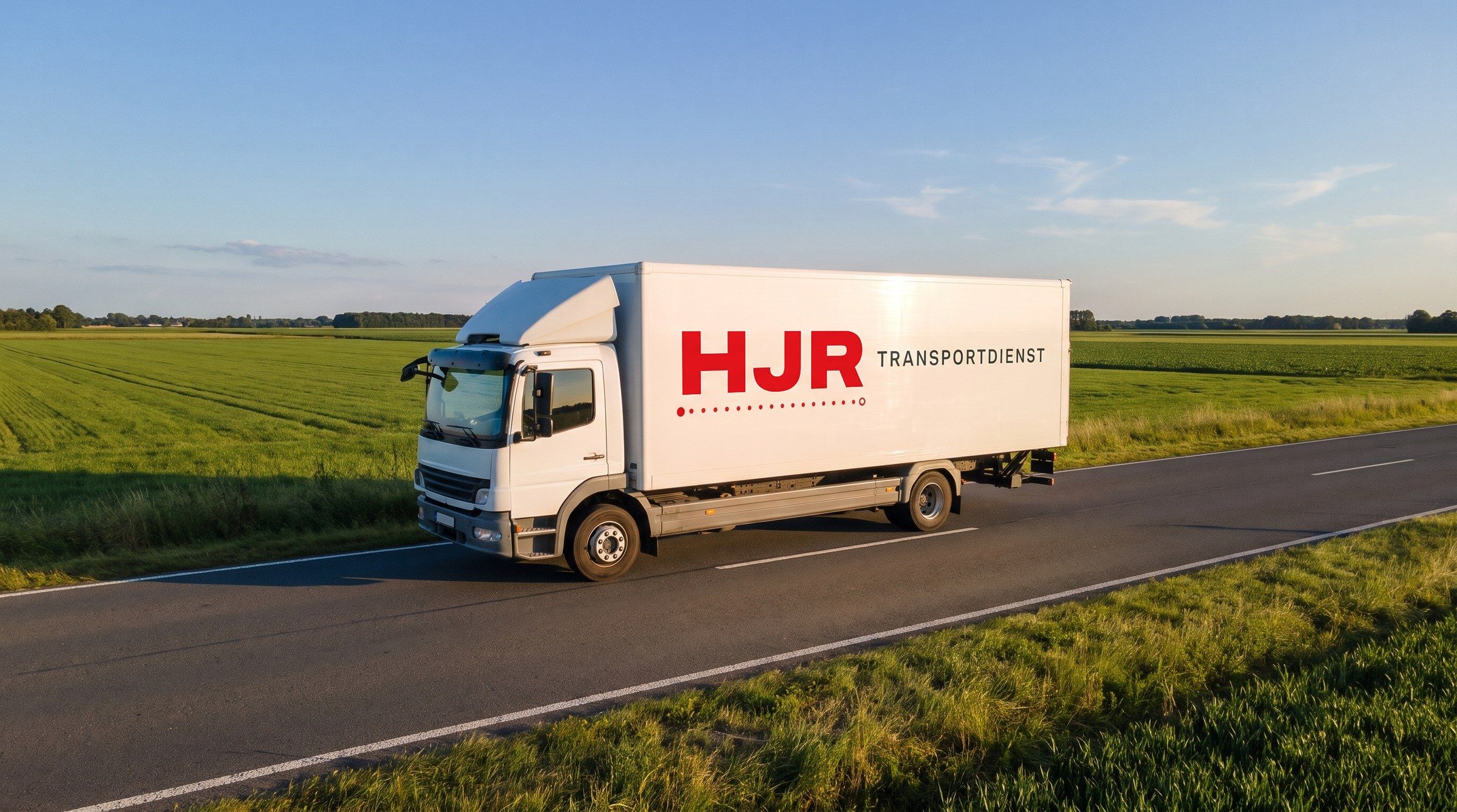 HJR 12-tonne truck on a country road through fields in Lower Saxony